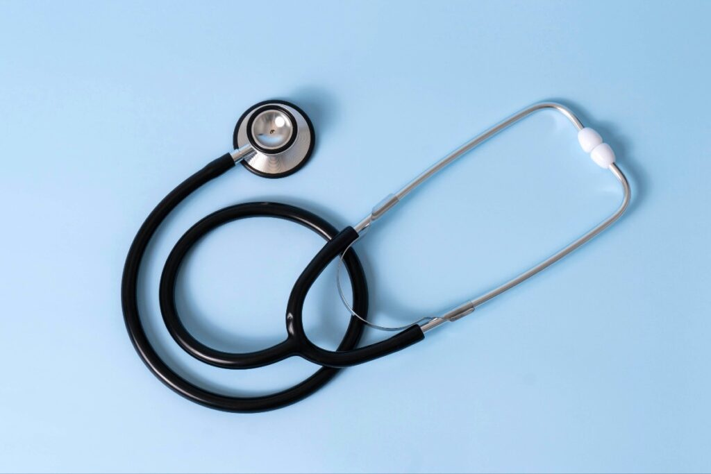 Medical stethoscope resting on a light blue background, ready for auscultation checks the heart and lungs