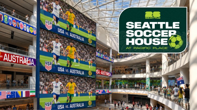 Indoor arena with giant screens showing USA vs. Australia soccer matches and a Seattle Soccer House sign overheads.