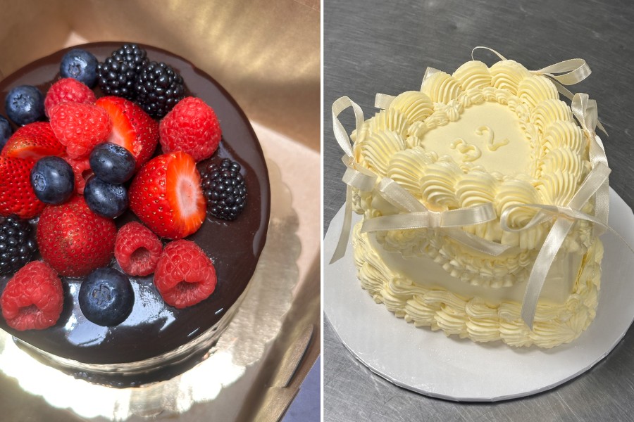 Two cakes side by side: left a glossy chocolate cake topped with raspberries, strawberries, blueberries, and blackberries; right a white frosted cake with cream piping and ribbon accents.