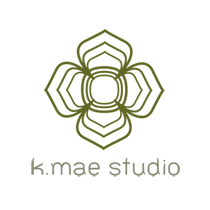 k-mae-studio - junglecity.com Abstract landscape icon: dark olive hill above a lighter green wavy ground or horizon.