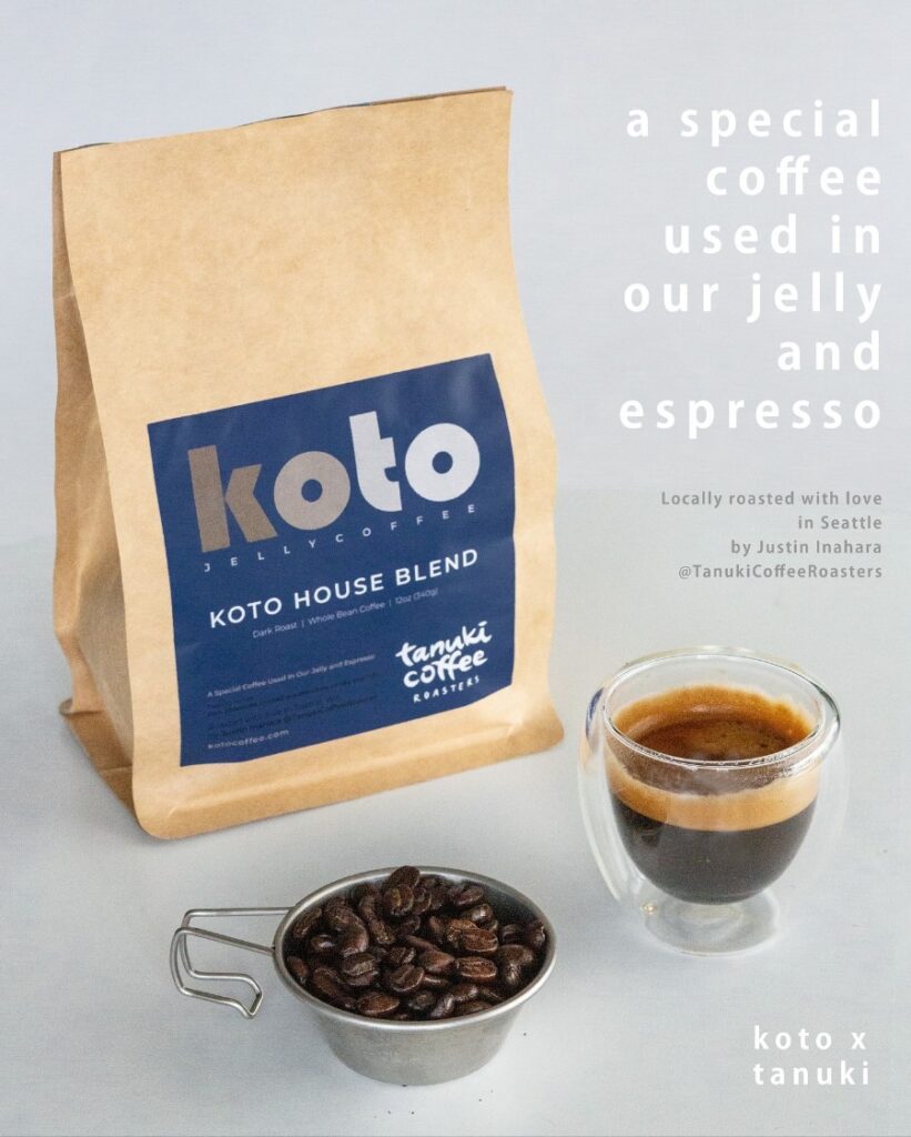 Koto jelly coffee bag with a blue label beside a glass cup of espresso and a metal scoop of roasted beans on a light background.