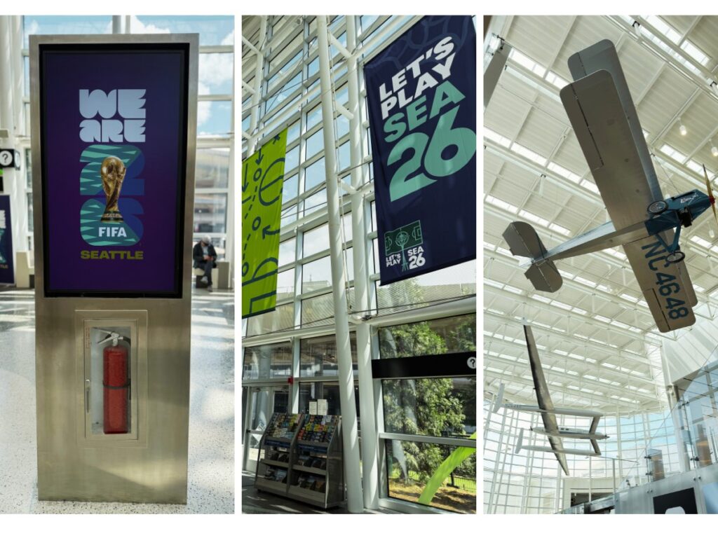Triptych collage: left panel shows a stainless display with a purple FIFA Seattle poster and a fire extinguisher; middle panel features banners hanging in a glass atrium, including a dark blue banner reading "LET'S PLAY SEA 26"; right panel shows a large model airplane suspended from the ceiling of a bright indoor atrium.