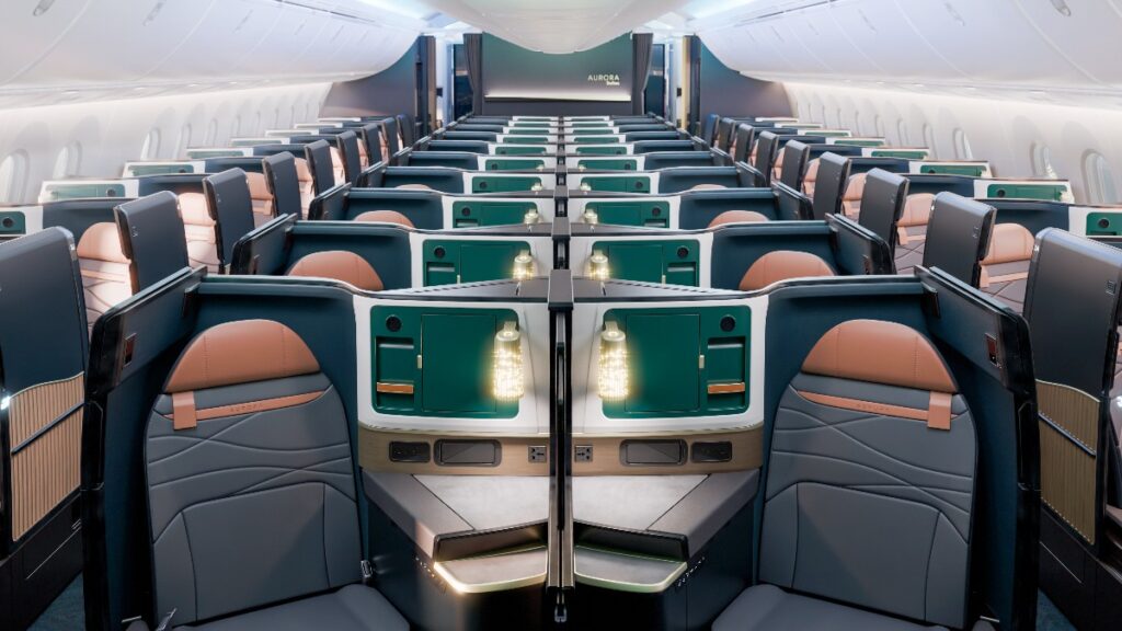 alaska-airlines-aurora - junglecity.com Symmetrical business-class cabin with private suites, teal panels, and orange-brown seats.