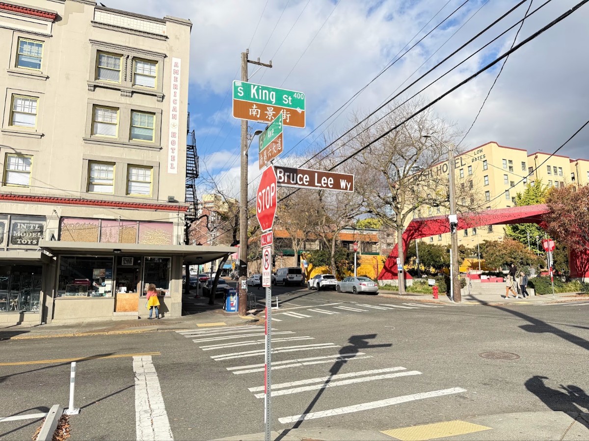 Intersection scene at S King St and Bruce Lee Wy with a crosswalk and stop sign in view.