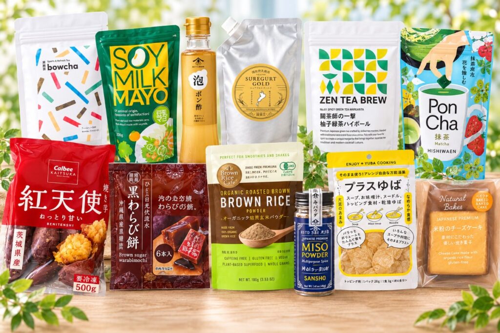 Assorted Japanese snacks and pantry items arranged on a wooden table, including chips, powders, teas, and cookies.